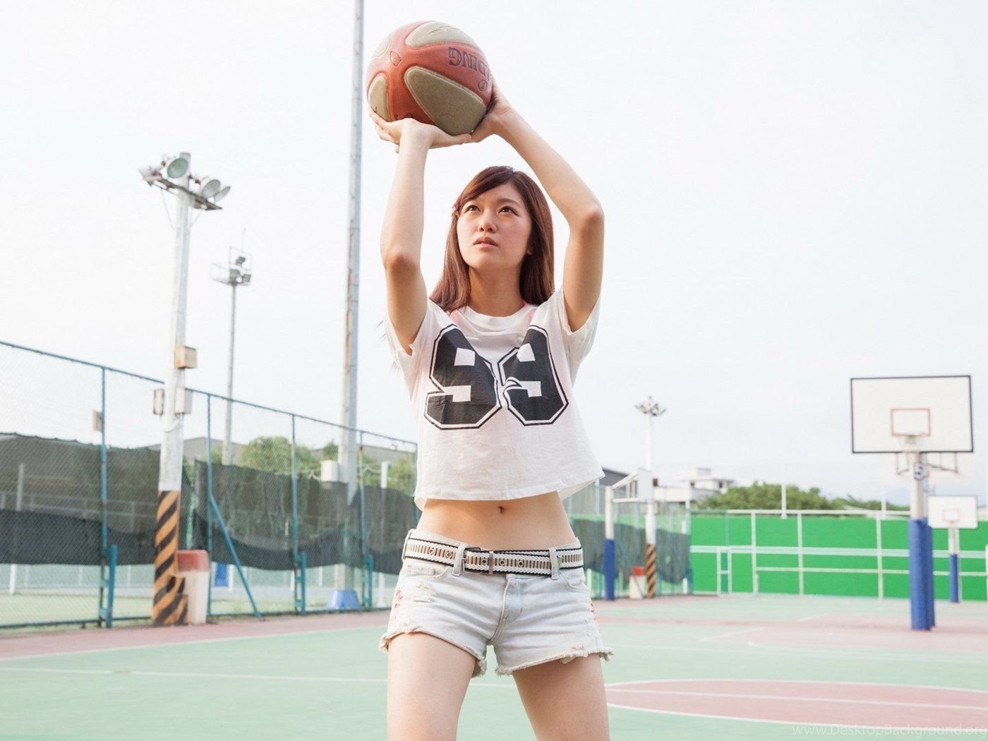 Asian girl two basketballs