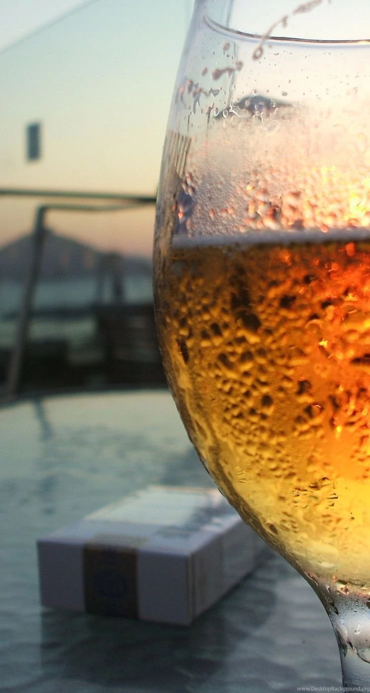 A glass of beer in front HD wallpaper_744x1392.jpg