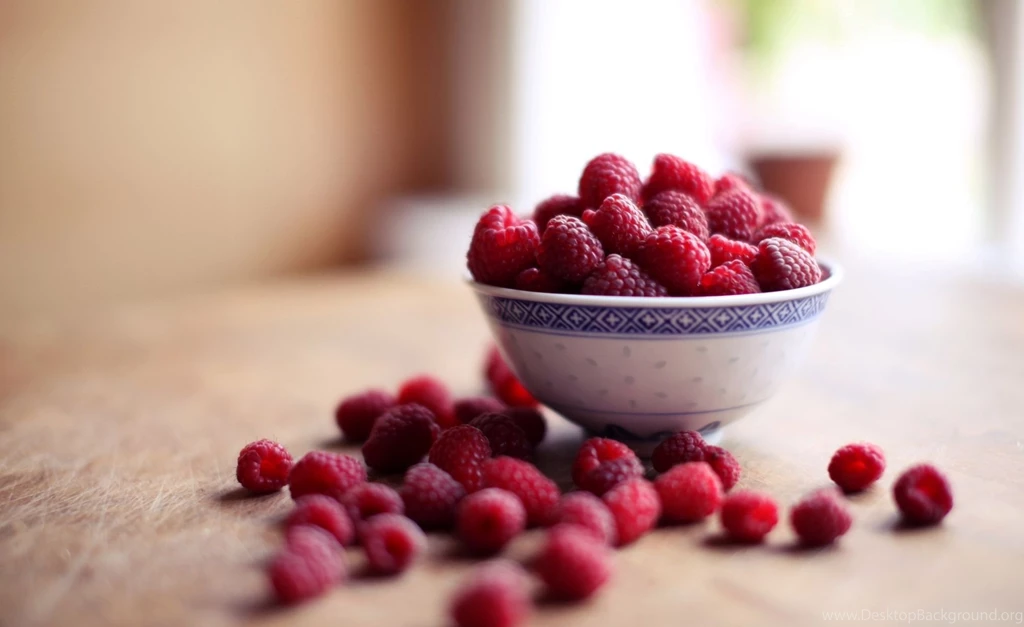 Fresh Ripe Raspberry In Glass Bowl On Black Backgrounds