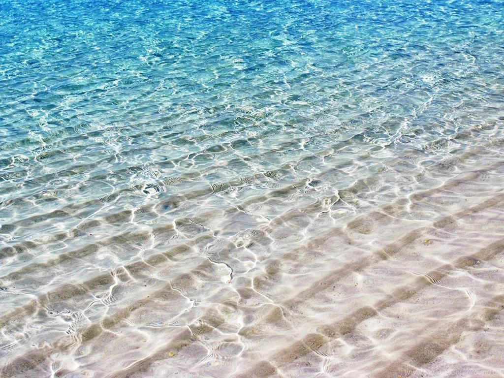 Translucent Sea Water Shimmer Over White Sand (