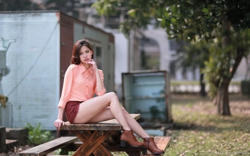 Cute asian girl on a wooden table under a tree 25769.jpg