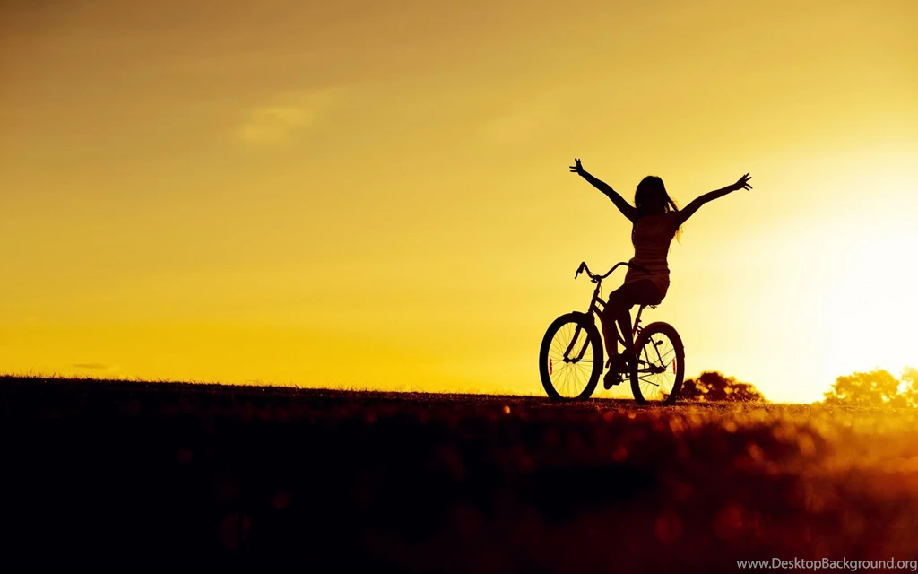 Girl bicycle sunset wide.jpg
