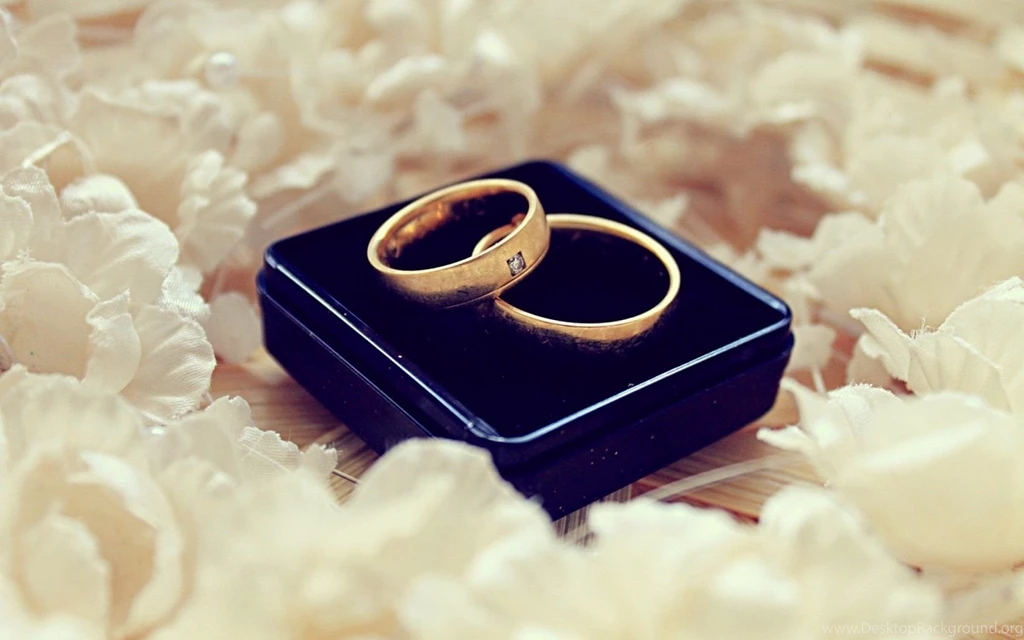 Two Wedding Rings With White Flowers
