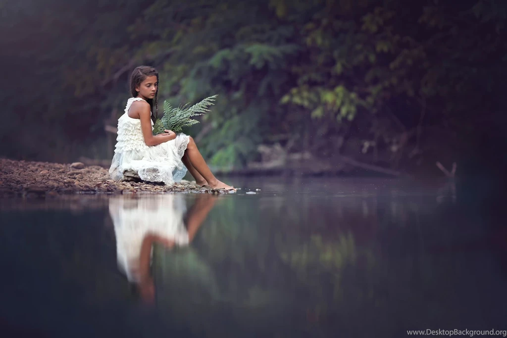 Sad girl sitting beside river.jpg