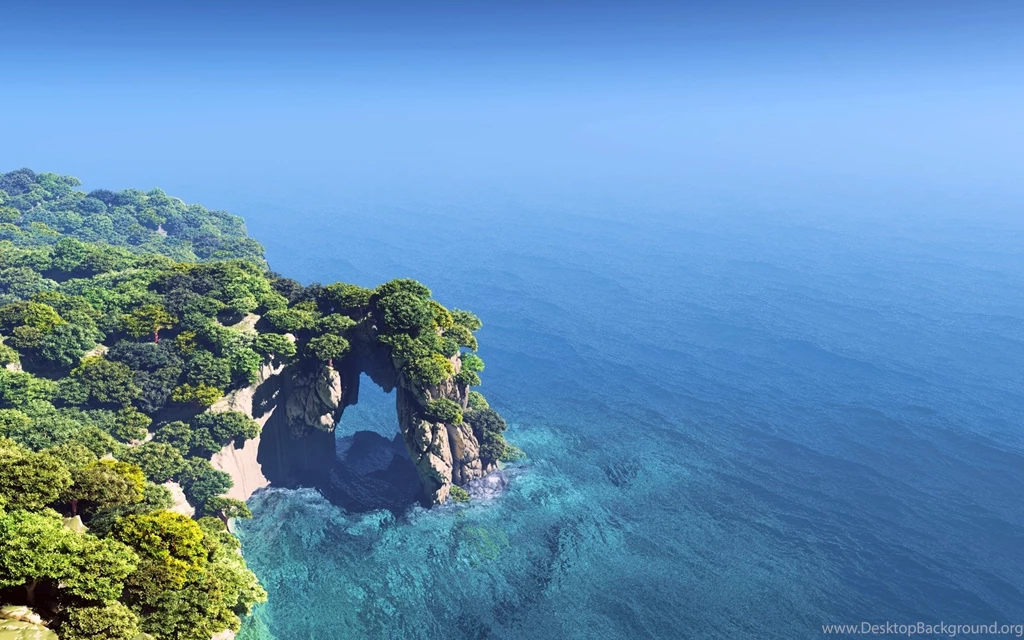 A Cliff With Vegetation In Ocean