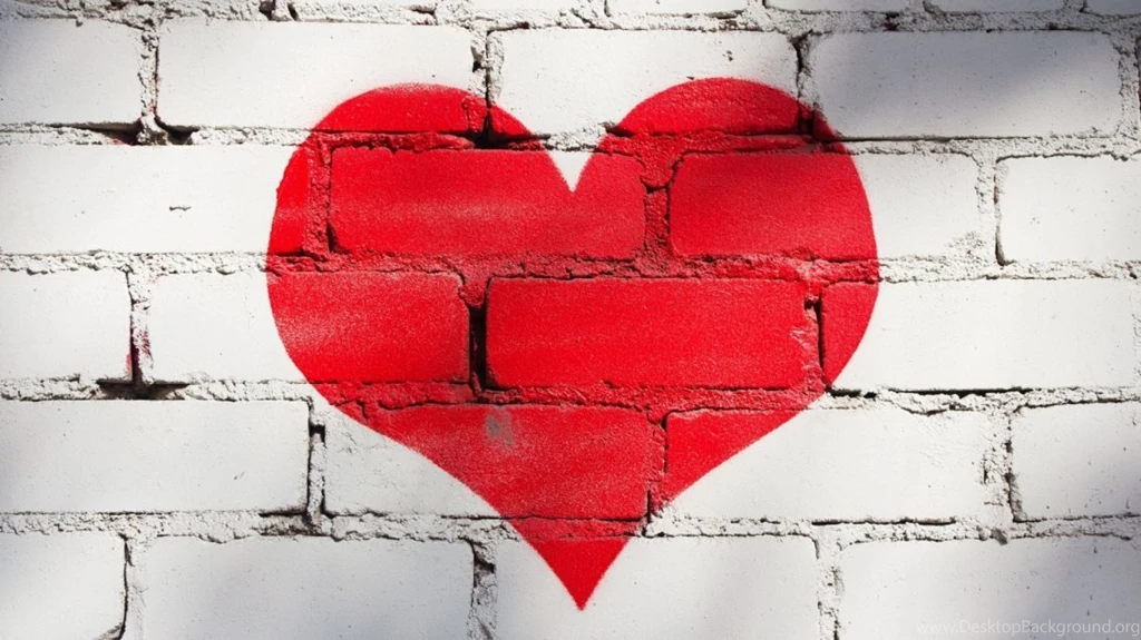 A Big Red Heart Painted On The Wall Made Of Brick