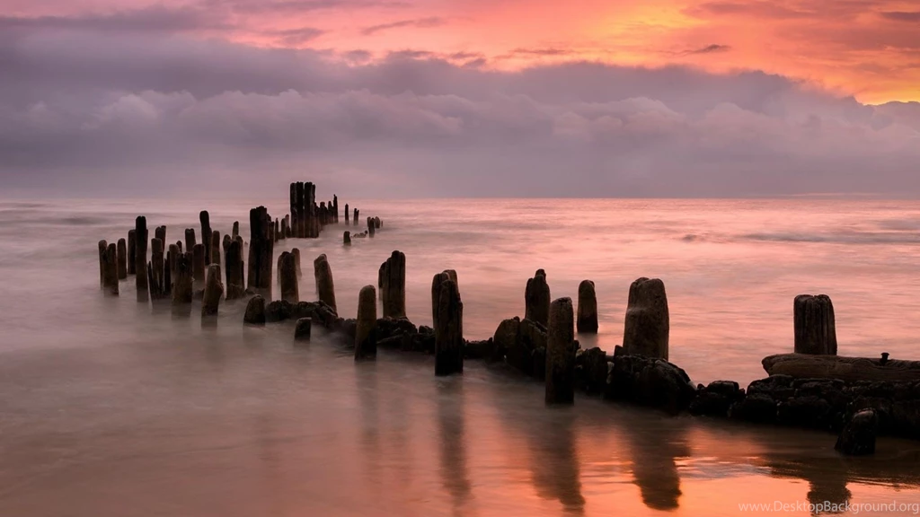 Broken Pier In A Beautiful Peach Colored Sea And Sky (