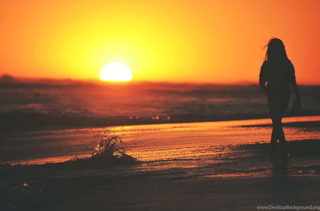 Girl Standing In Water At Sunset Silhouette
