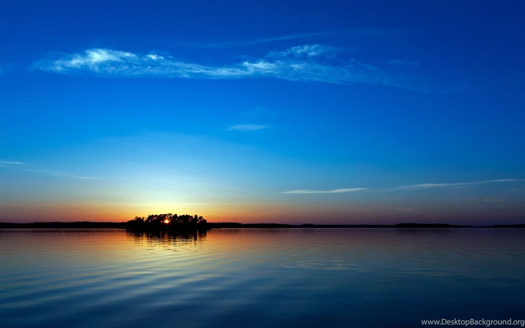 Both The Sea And The Sky Are Incredibly Blue, The Sun Is Setting ...