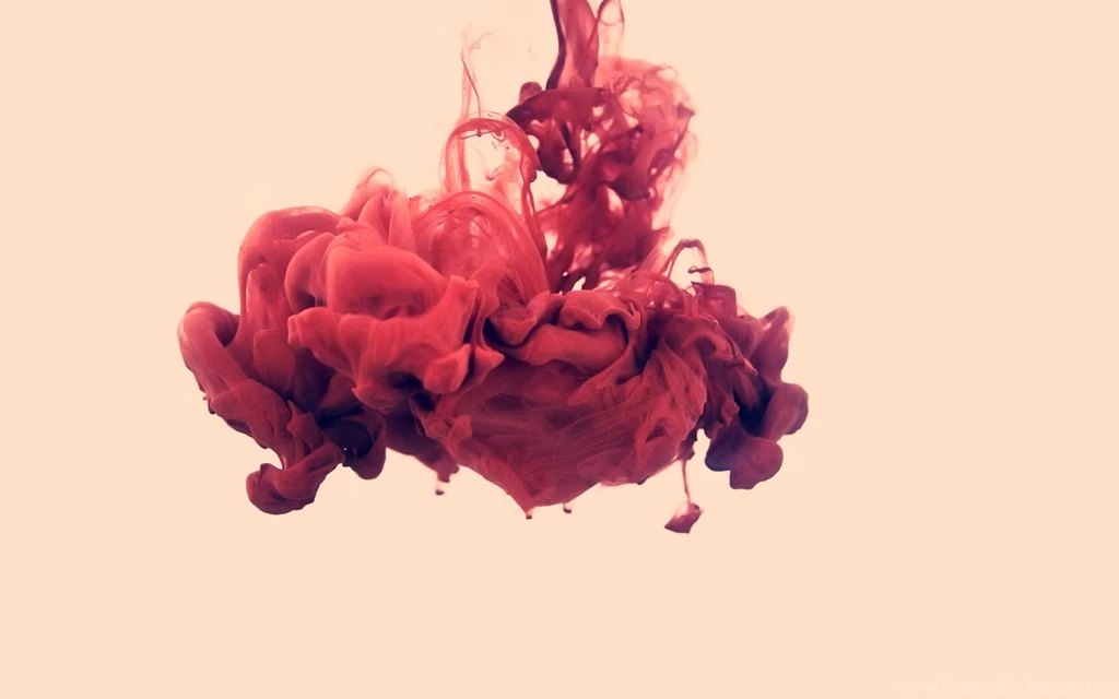 A Splash Of Red Paint In Water