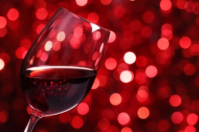 Glass Of Red Wine Against Red Bokeh Backgrounds