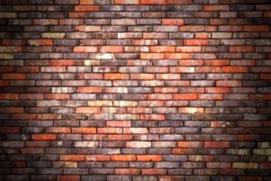 14972749 colorful brick wall background with black vignette