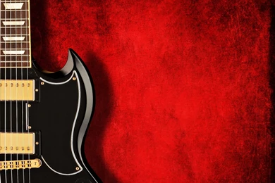 An Electric Black Guitar On Dark Red Backgrounds ...