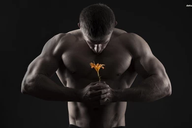 Muscular Man Holding A Lily Wallpapers