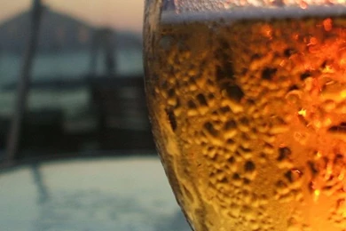 A glass of beer in front HD wallpaper_744x1392.jpg