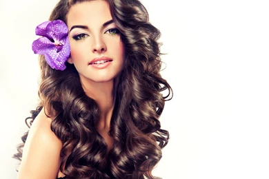 Beautiful Girl With Long Curly Brown Hair , Flower In Hair ...