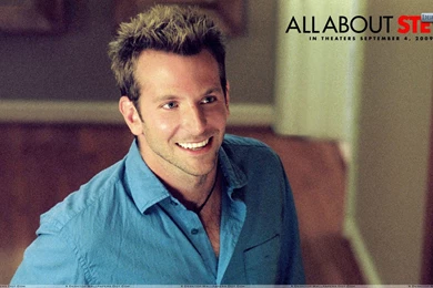 Bradley Cooper Smiling In Black Coat Outside Building Wallpapers