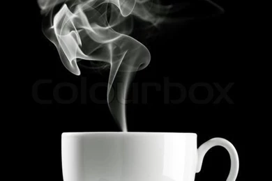 Coffee Cup Over The Table Against Black Backgrounds