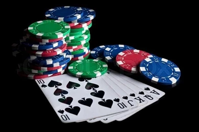 Royal Flush And Poker Chips On A Black Backgrounds