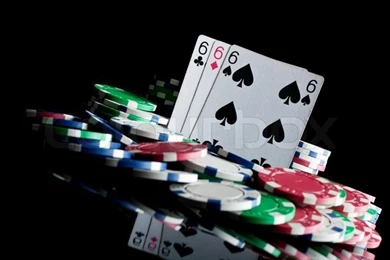 Three Sixes And Failure In Poker On A Black Stock Photo