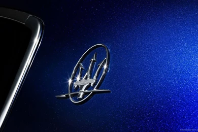 Download 1366x768 Blue Maserati Ghibli Logo Wallpapers