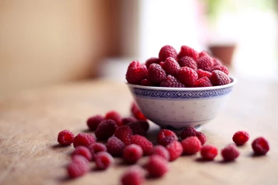 Fresh Ripe Raspberry In Glass Bowl On Black Backgrounds