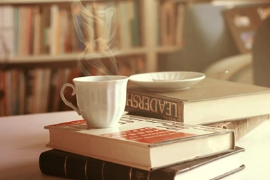 Drink Coffee From White Mug With Glasses And Book On Table