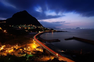 Some Kind Of Cove Or Harbour At Night With A Mountain In The ...