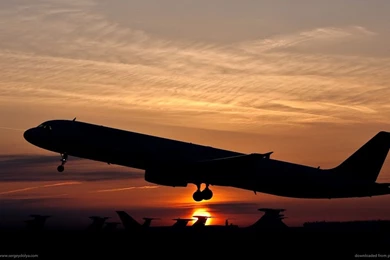 Download 1366x768 Silhouette Of An Ascending Plane Wallpapers