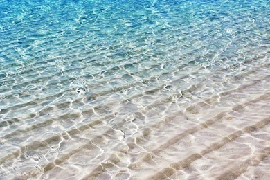 Translucent Sea Water Shimmer Over White Sand   (