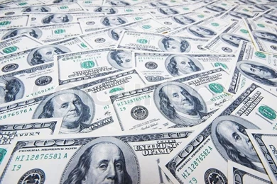 Stack Of Dollars On Money Backgrounds Stock Photo