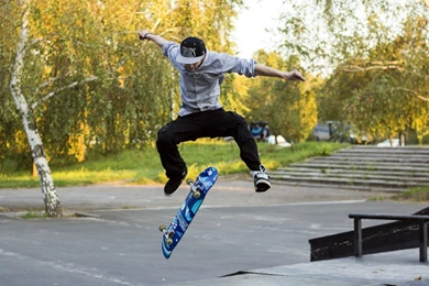 A Skater Jumping On A Blue Skateboard