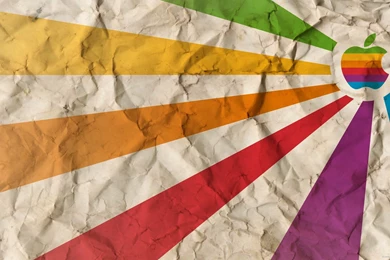 Download 2560x1440 Rainbow Apple On A Crumbled Paper Wallpapers