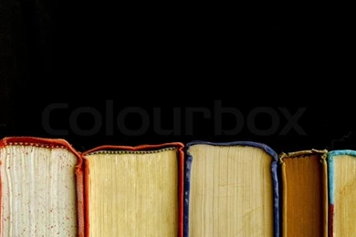 Looking At Row Of Books Across The Bindings Against A Black ...