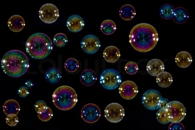 Soap Bubbles Floating In Front Of A Black Backgrounds