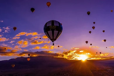 Hot Air Balloons Flying At Sunrise (with The Sandia Mountains In ...