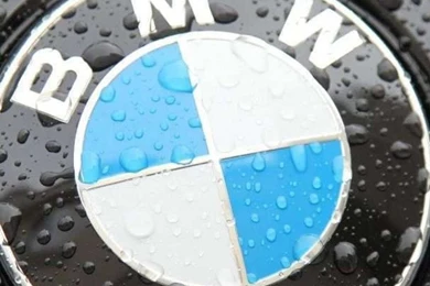 The bmw logo on a black car with raindrops 1080x1920.jpg