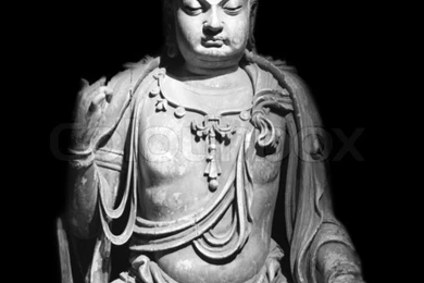 Statue Of Buddha Isolated Against Black Backgrounds