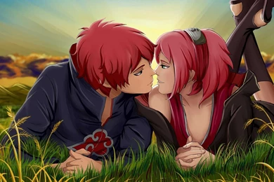 An anime couple with red hair kissing in the grass