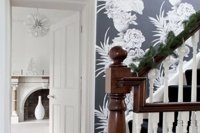 Hallway With Oversized Black And Floral Wallpapers