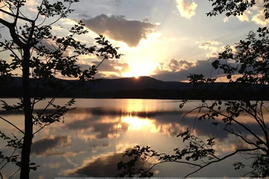 Sunrise From Behind The Mountains And Reflection In The Water ...