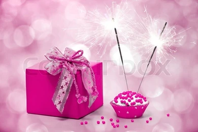 Birthday Cake With Sparkler And Gift On A Pink Backgrounds