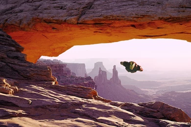 Iron Man Flying Through A Natural Arch