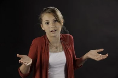 10034130 a teenage female girl asking a question against a black ...