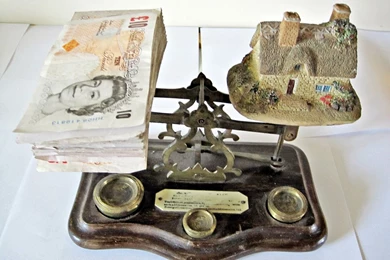 Money And House On Scales