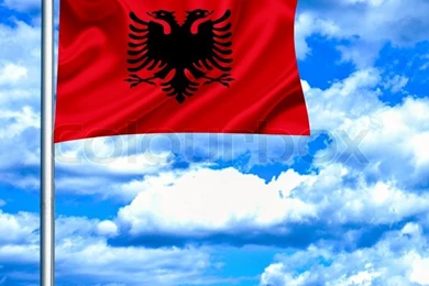 Albania Waving Flag Against Blue Sky