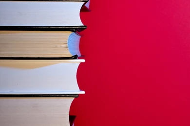 Stack Of Hardcover Encyclopedias Against Red Backgrounds