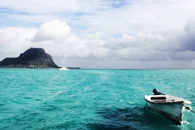 Download 1920x1080 A Boat In A Deep Blue Sea Wallpapers