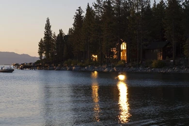 Morning Sun Reflecting Off A Lake House Window   (