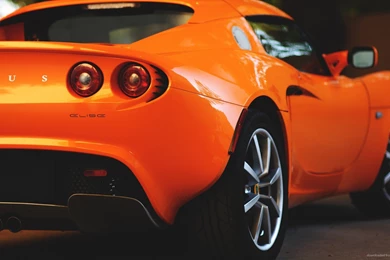 Download 1920x1080 Orange Lotus Elise Back Wallpapers